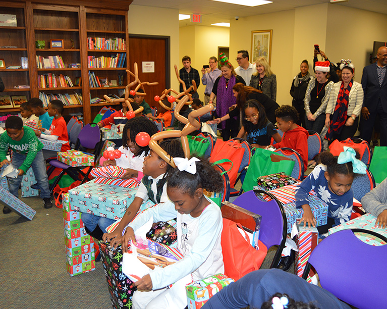 Photo of children opening up presents
